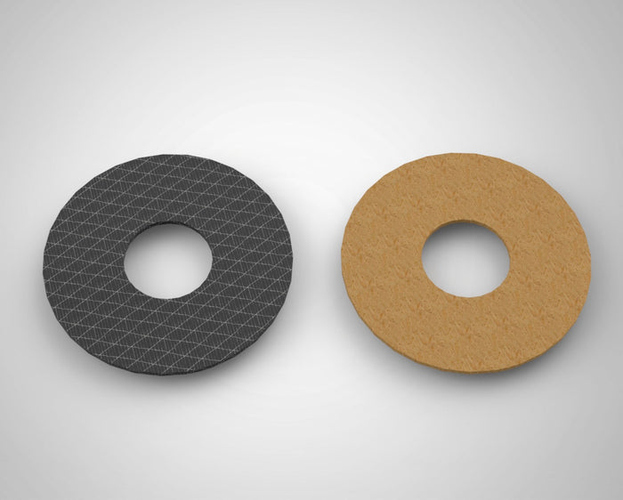 Modern fly reel drag system components showing carbon fiber discs, stainless plates, cam ramp, lever, and thrust plate designed for controlled slippage under load.