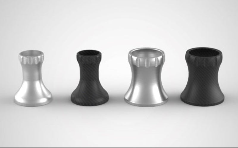 Four metallic objects, two silver and two black, arranged in a row on a light gray background.